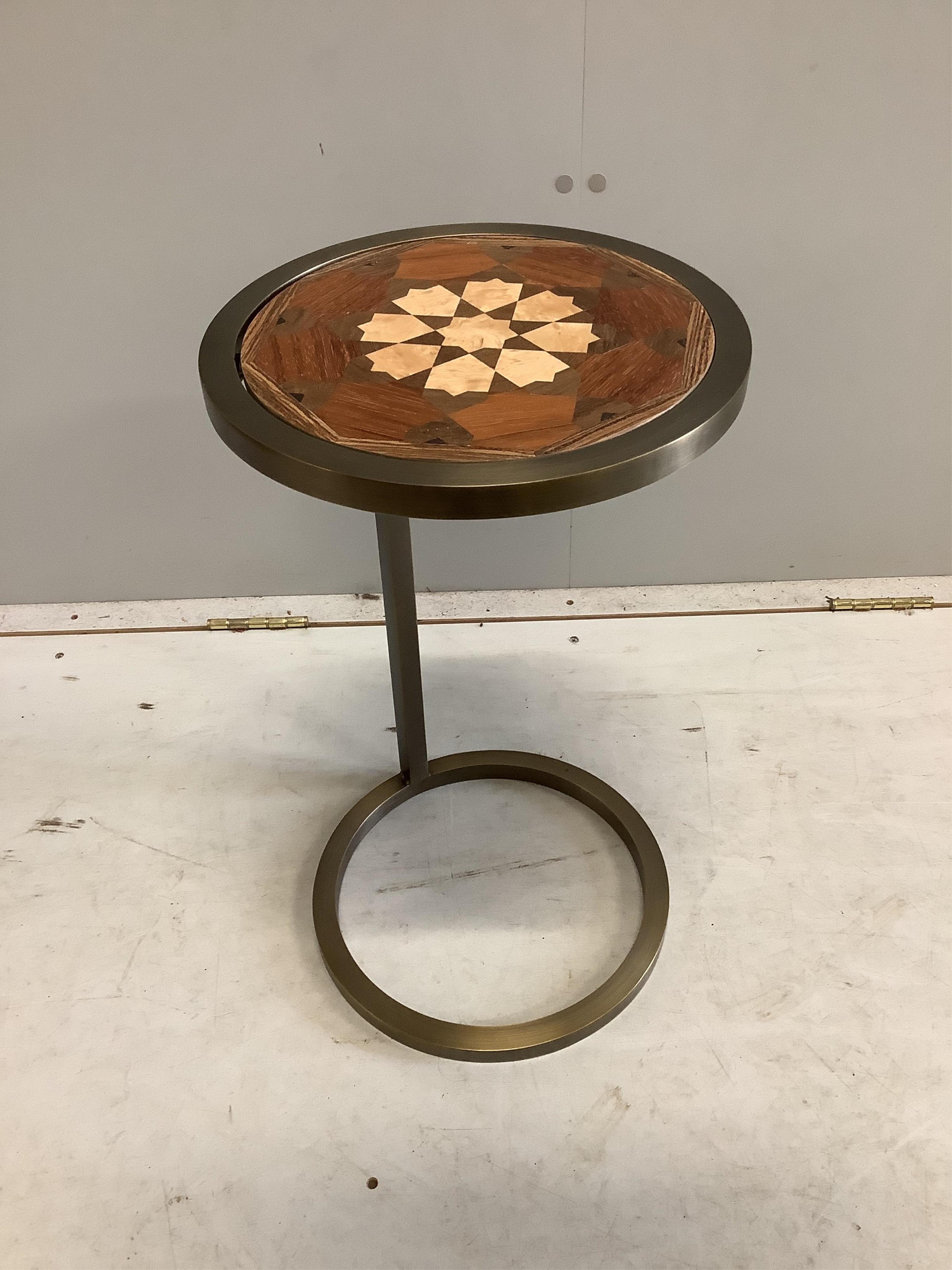 A Contemporary circular occasional table with reversible parquetry inlaid top, diameter 30cm, height 53cm. Condition - good